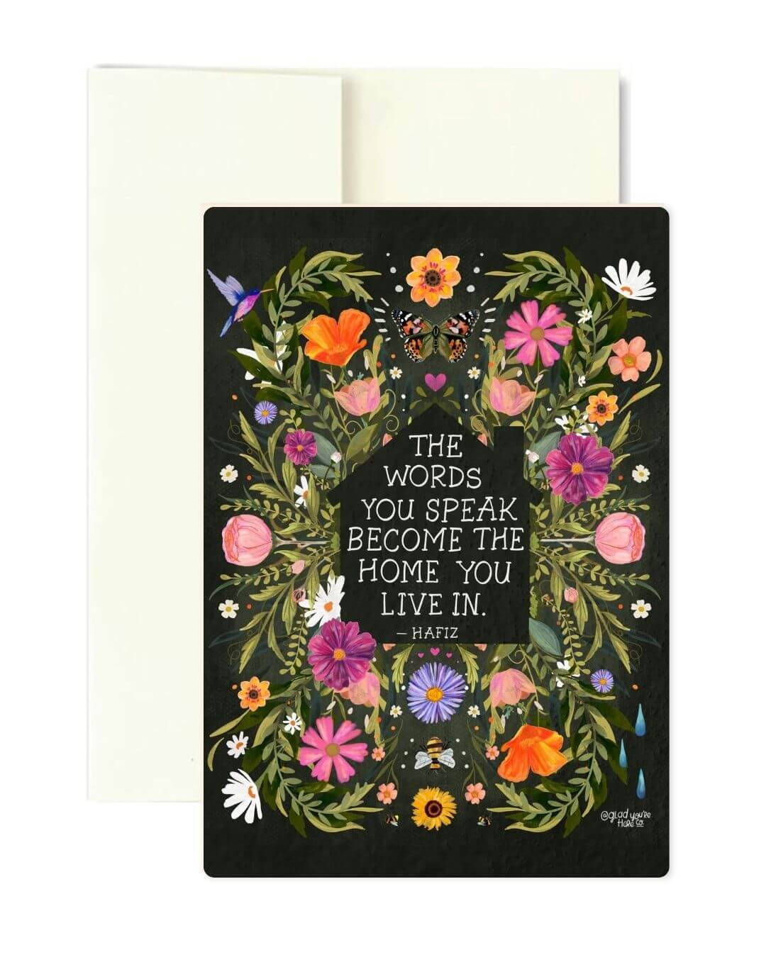 A square greeting card with a black background and a colorful floral wreath design surrounding the quote, 'THE WORDS YOU SPEAK BECOME THE HOME YOU LIVE IN. -Hafiz'.