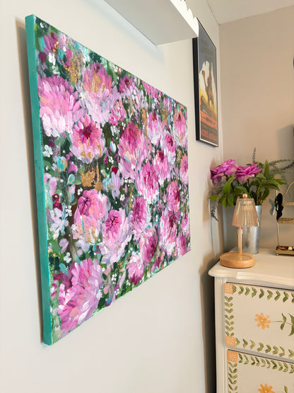 Floral painting on a wall with decorative items below
