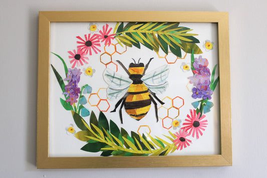 Framed artwork with a bee and floral design on a white background