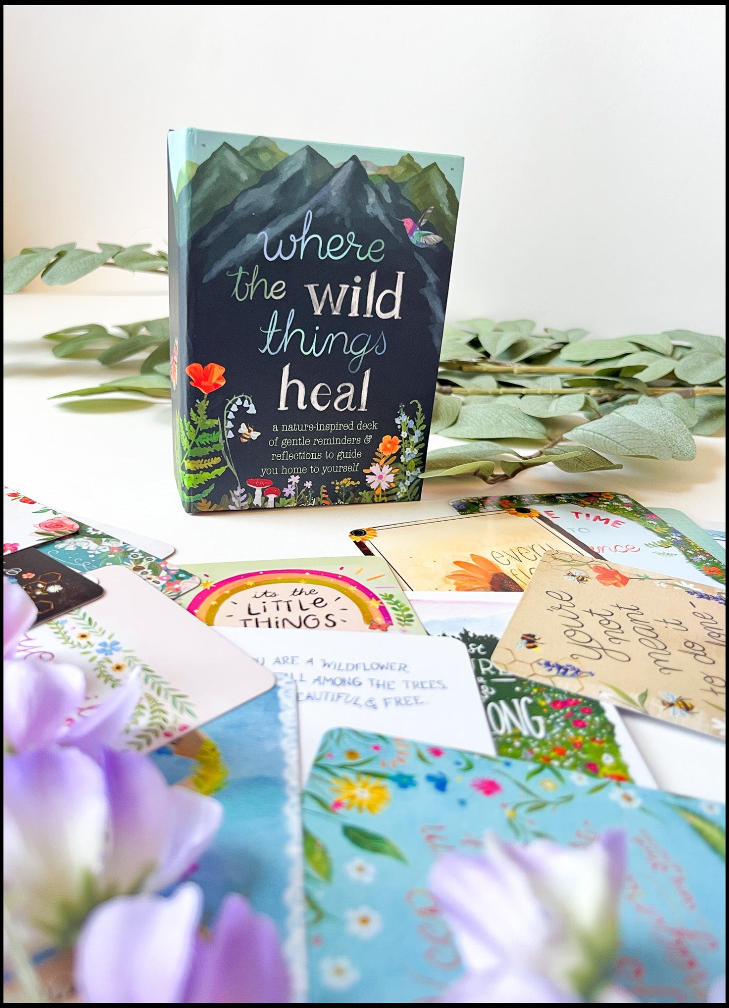 Card deck for therapists and caregivers titled 'Where the Wild Things Heal' surrounded by colorful cards on a light background