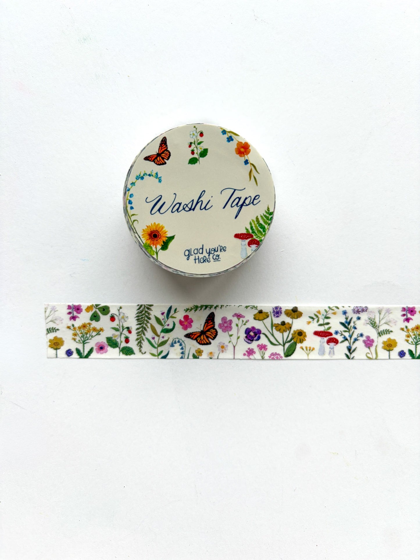 Washi tape with floral design and a container labeled 'Washi Tape' on a white background