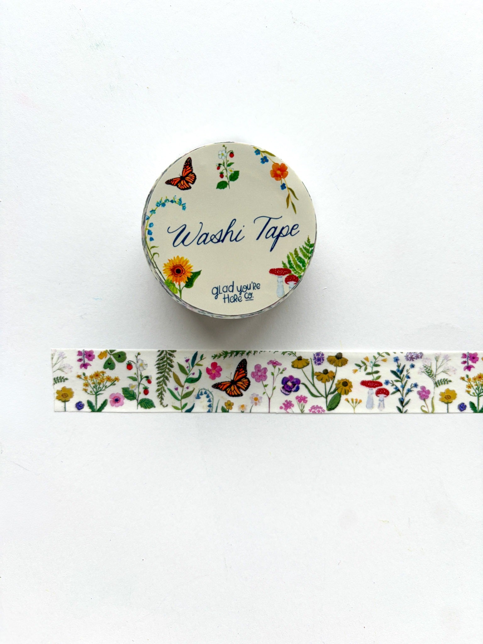 Washi tape with floral design and a container labeled 'Washi Tape' on a white background