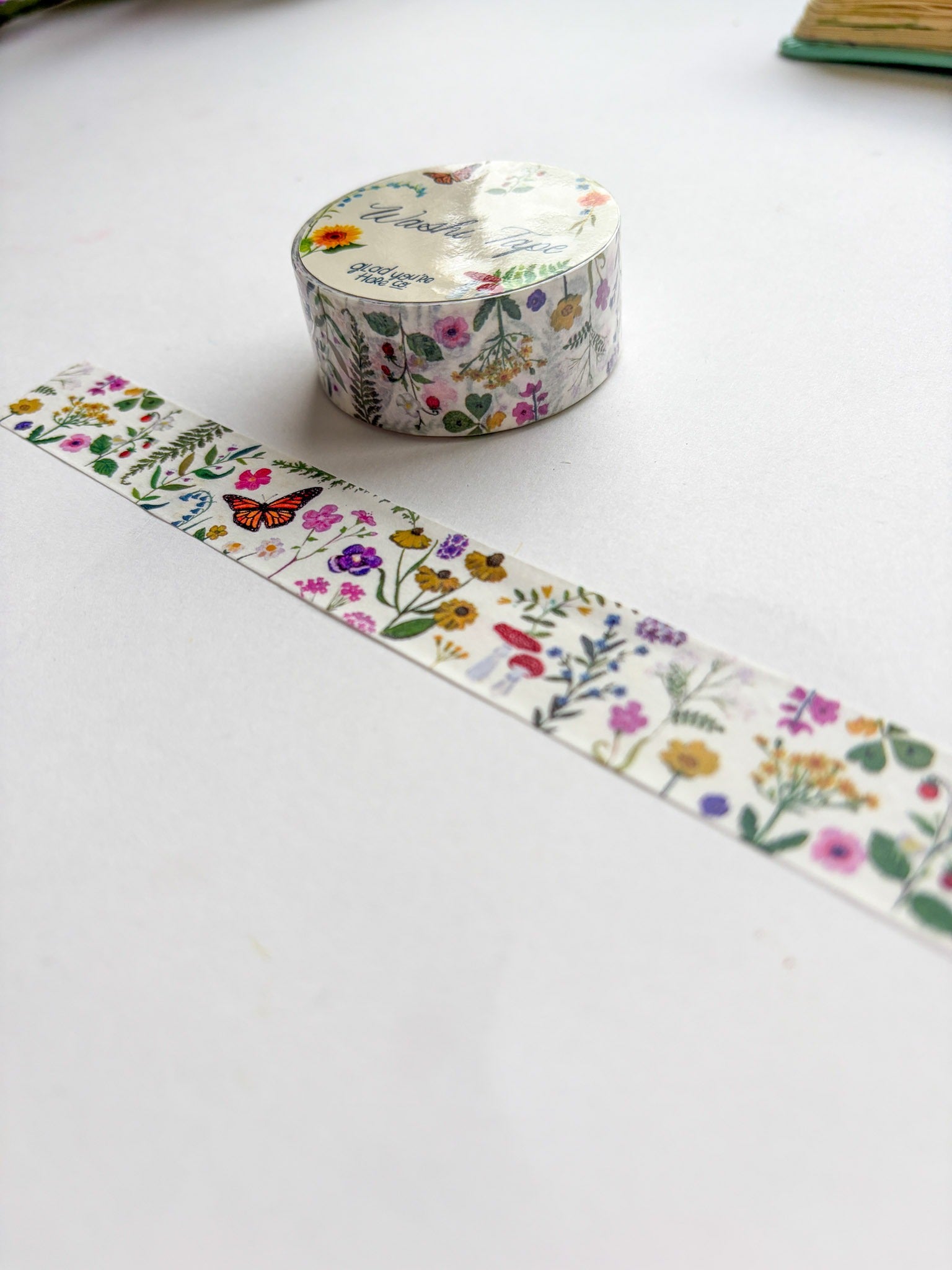 Decorative washi tape with floral design on a white surface