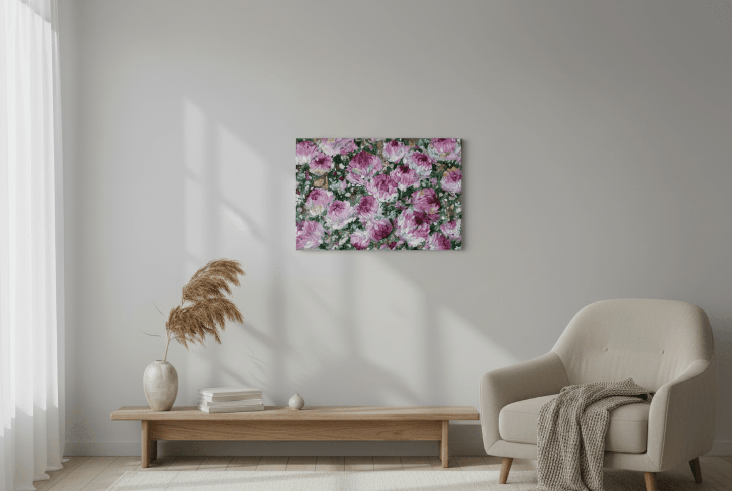 Floral painting on a wall in a living room with a chair and coffee table.