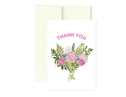 A white greeting card with the words 'THANK YOU' in pink above a watercolor-style bouquet of pink and purple flowers with green leaves, shown with an off-white envelope behind it on a white background.