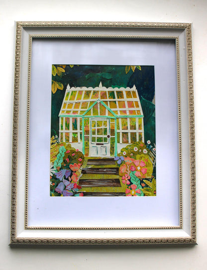 Framed artwork of a greenhouse with flowers on a white wall