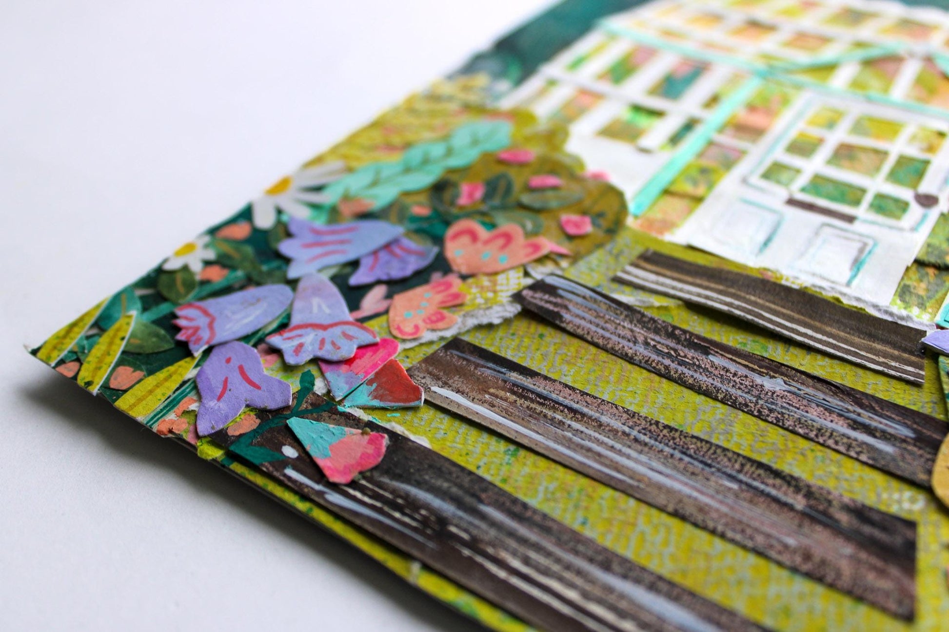 Close-up of a colorful scrapbook page with floral designs and text.