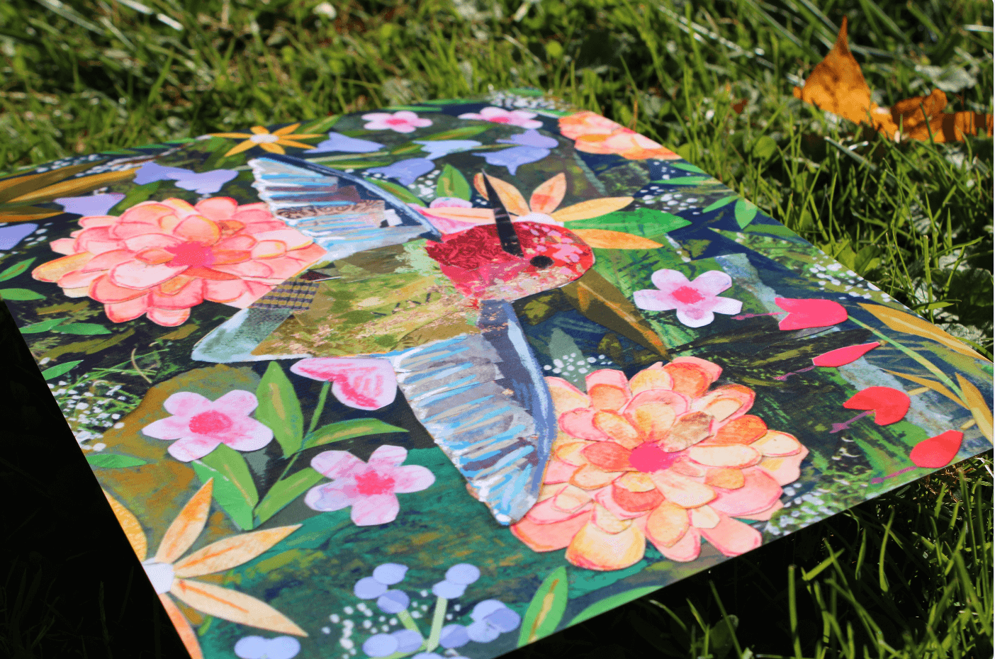 Colorful quilt with floral and butterfly design on grass