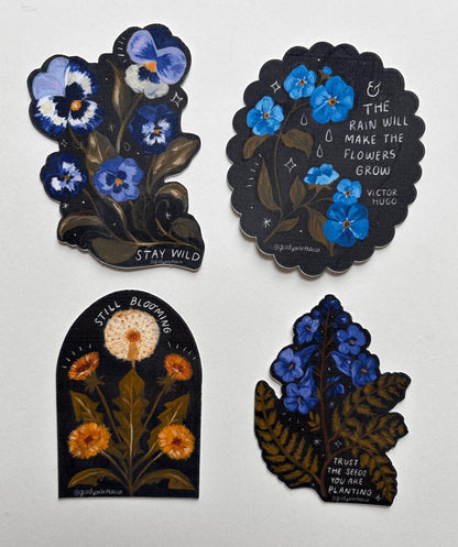 Four decorative stickers with floral designs and text on a white background