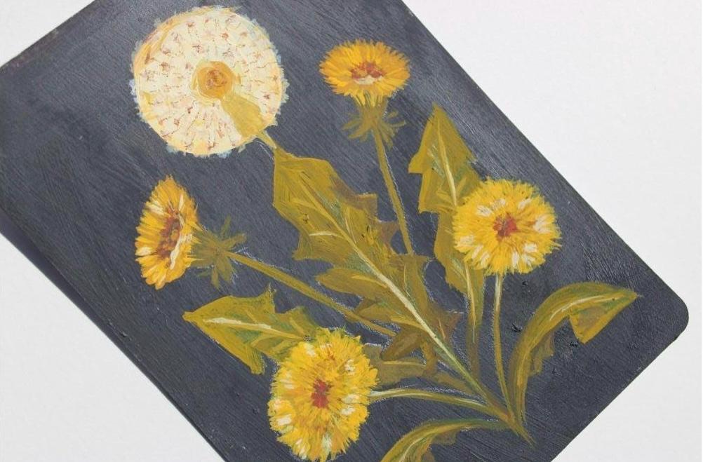 Placemat with yellow dandelion flowers on a dark background