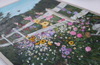 Close-up of a garden scene with flowers and a ladder.