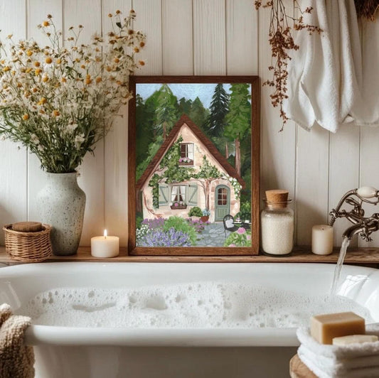 Bathroom with a bathtub, framed artwork of a house, and decorative items.