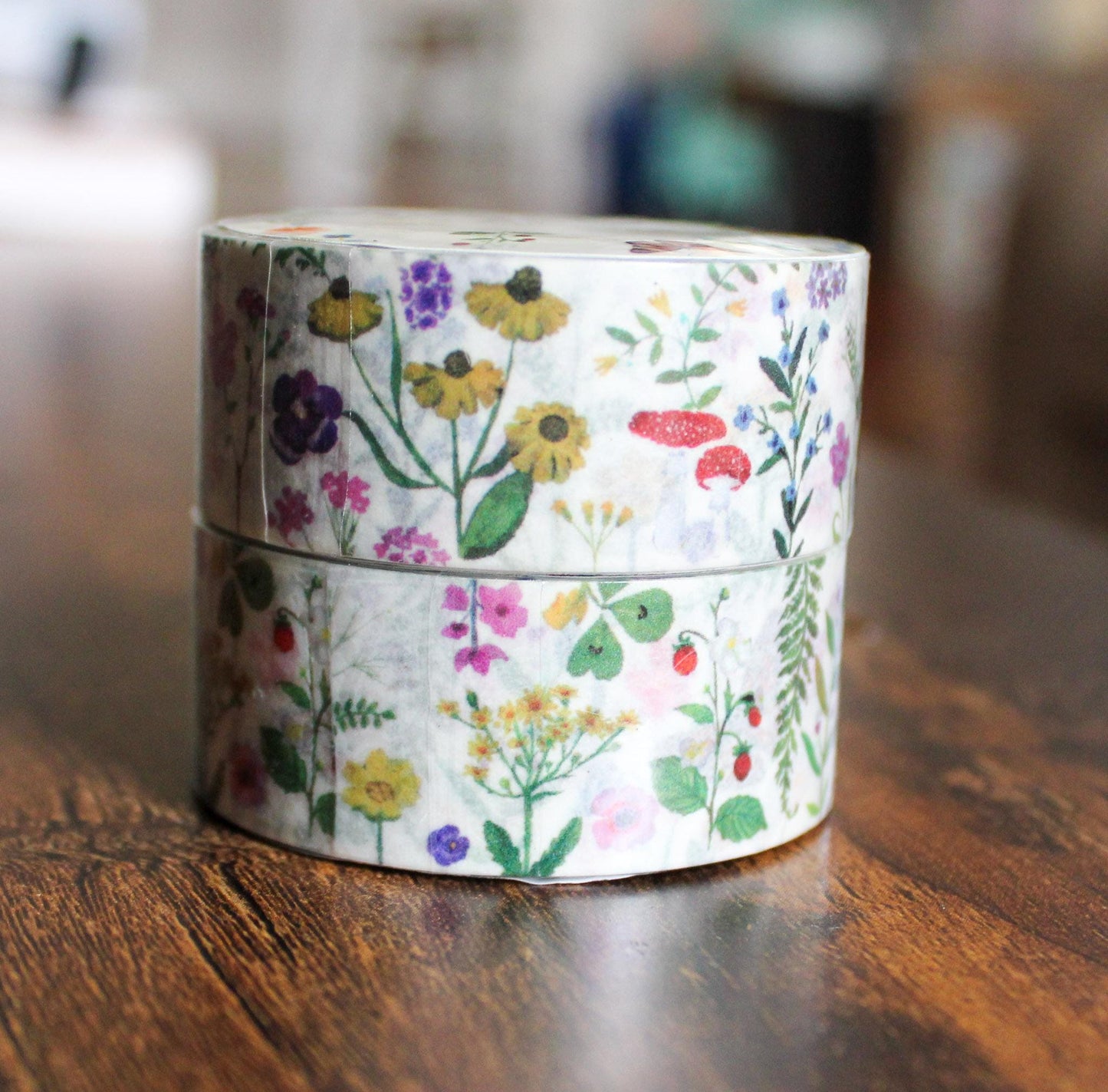 Two rolls of floral tape stacked on a wooden surface