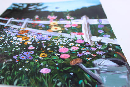 Colorful garden scene with flowers and a watering can on a printed material.