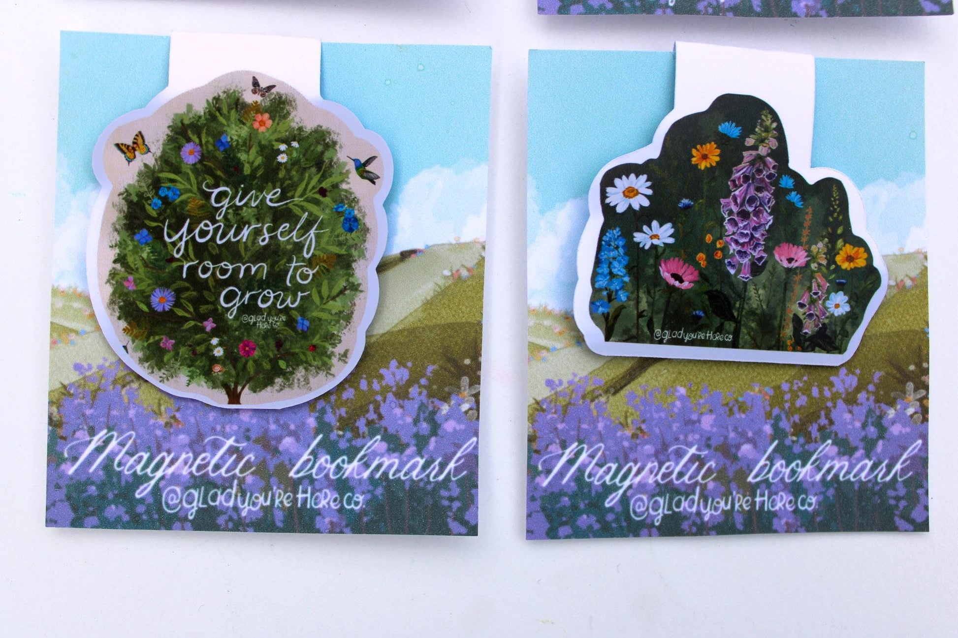 Two magnetic bookmarks with floral designs and text on a white background