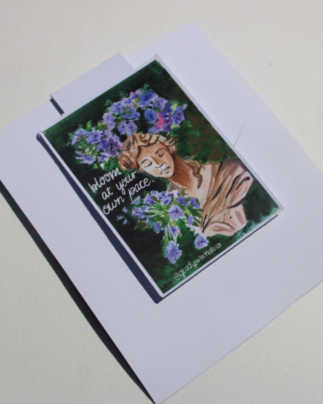 Greeting card with a design of a person with flowers and text on a white background
