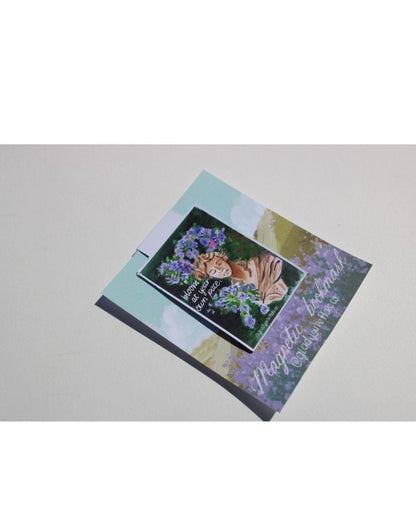 Decorative magnetic bookmark with floral design and text on a light gray background