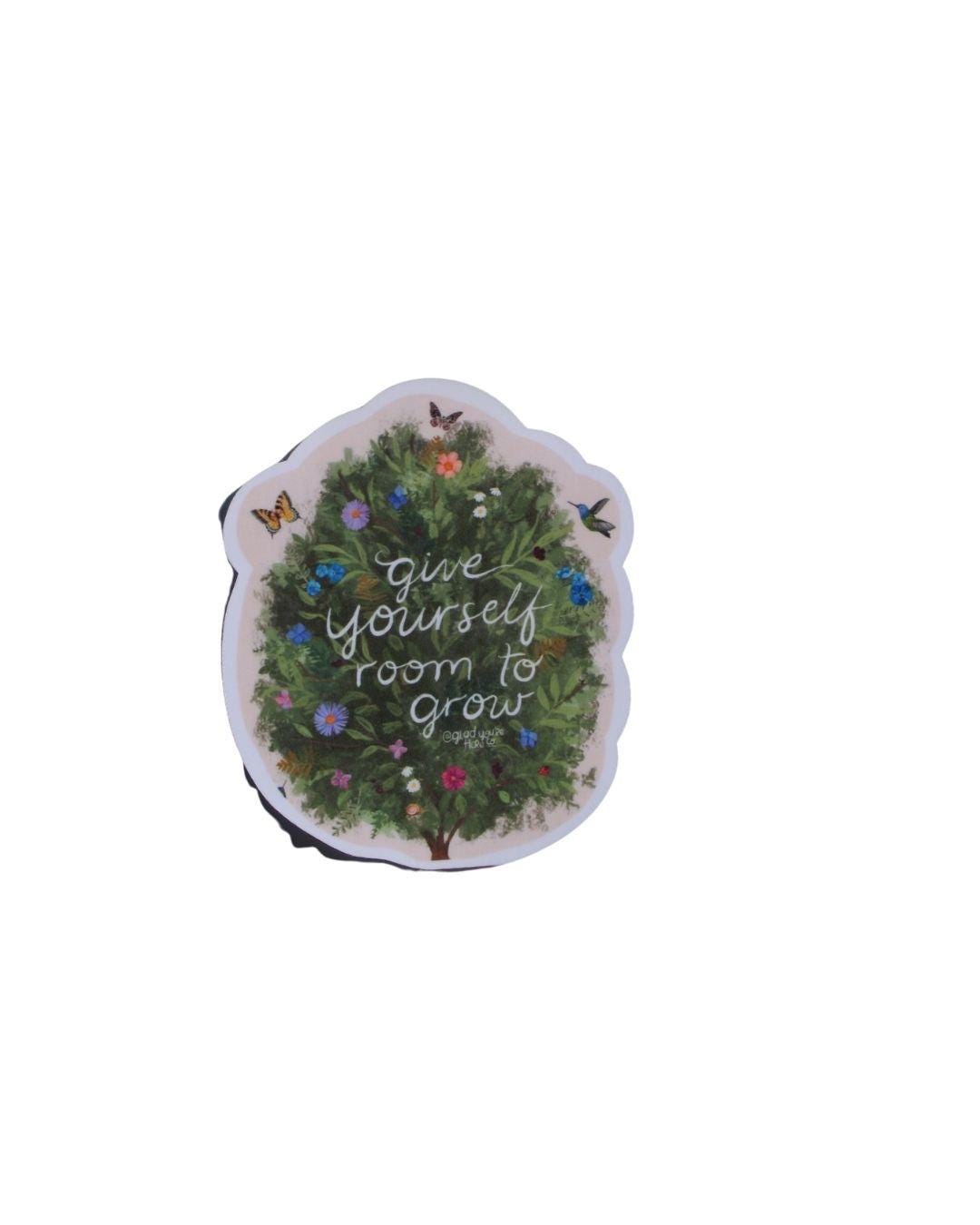 Decorative sticker with text 'Give yourself room to grow' with growign shrub, birds, and butterflies on a white background