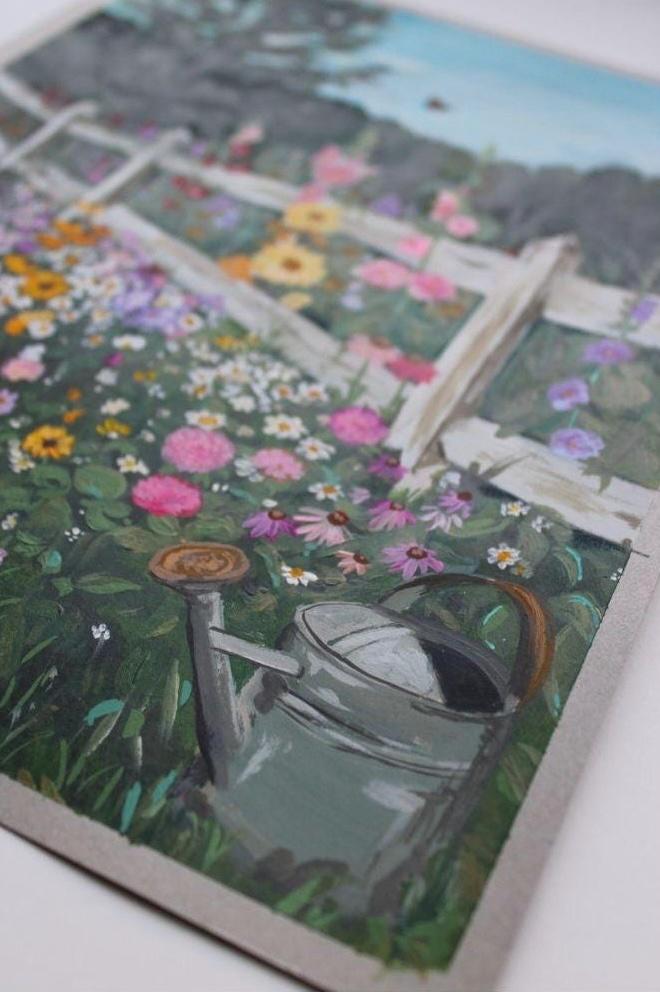 Garden scene with flowers and a watering can on a textured surface
