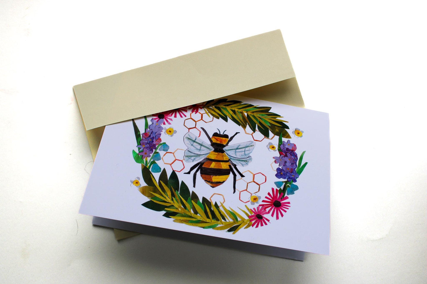 Greeting card with a bee and floral design on a white background