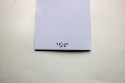 back of greeting card with 'Glad you're here co.' text on a plain background