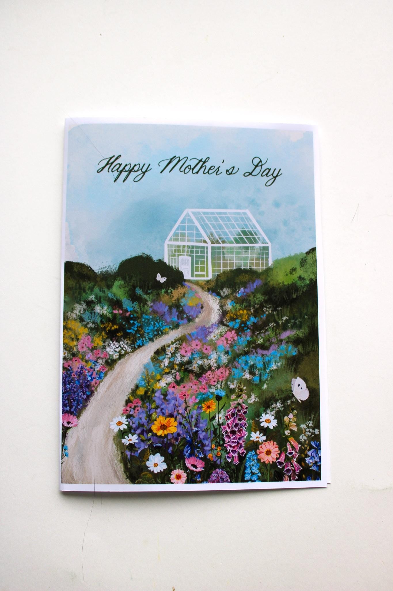 Greeting card with a garden scene and greenhouse, featuring 'Happy Mother's Day' text.