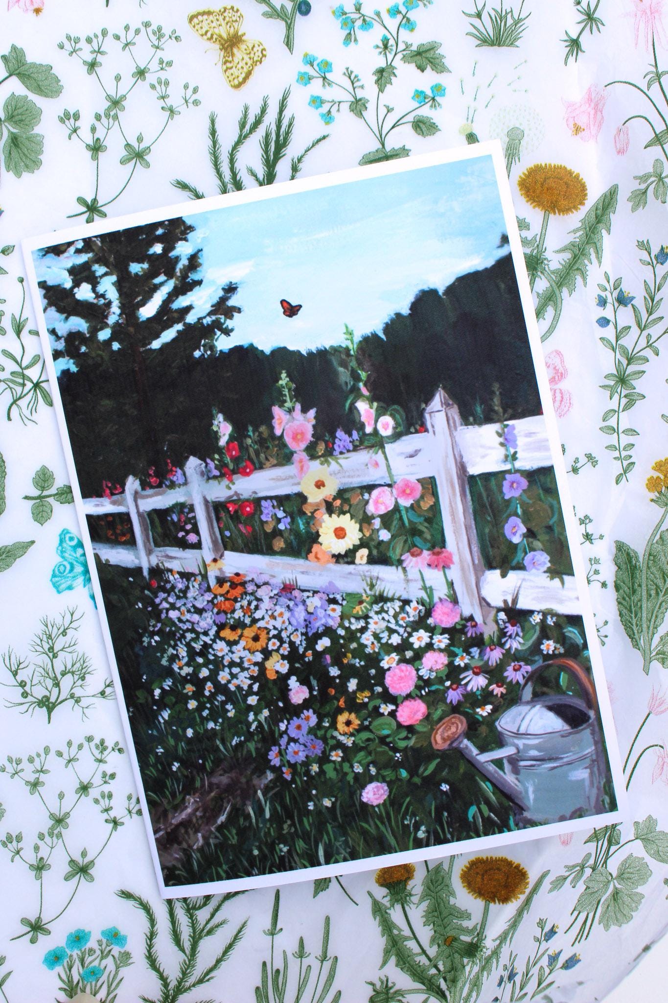 Garden scene with flowers and a white fence on a decorative floral background