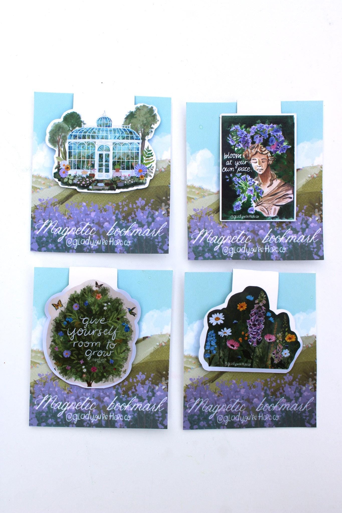 Four decorative magnetic bookmarks with nature-themed designs on a white background.