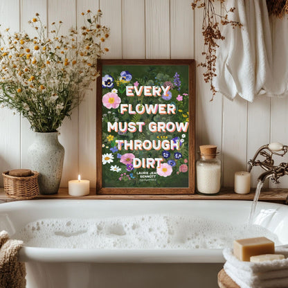Bathroom with a bathtub, flowers, and a motivational sign on a wooden shelf.