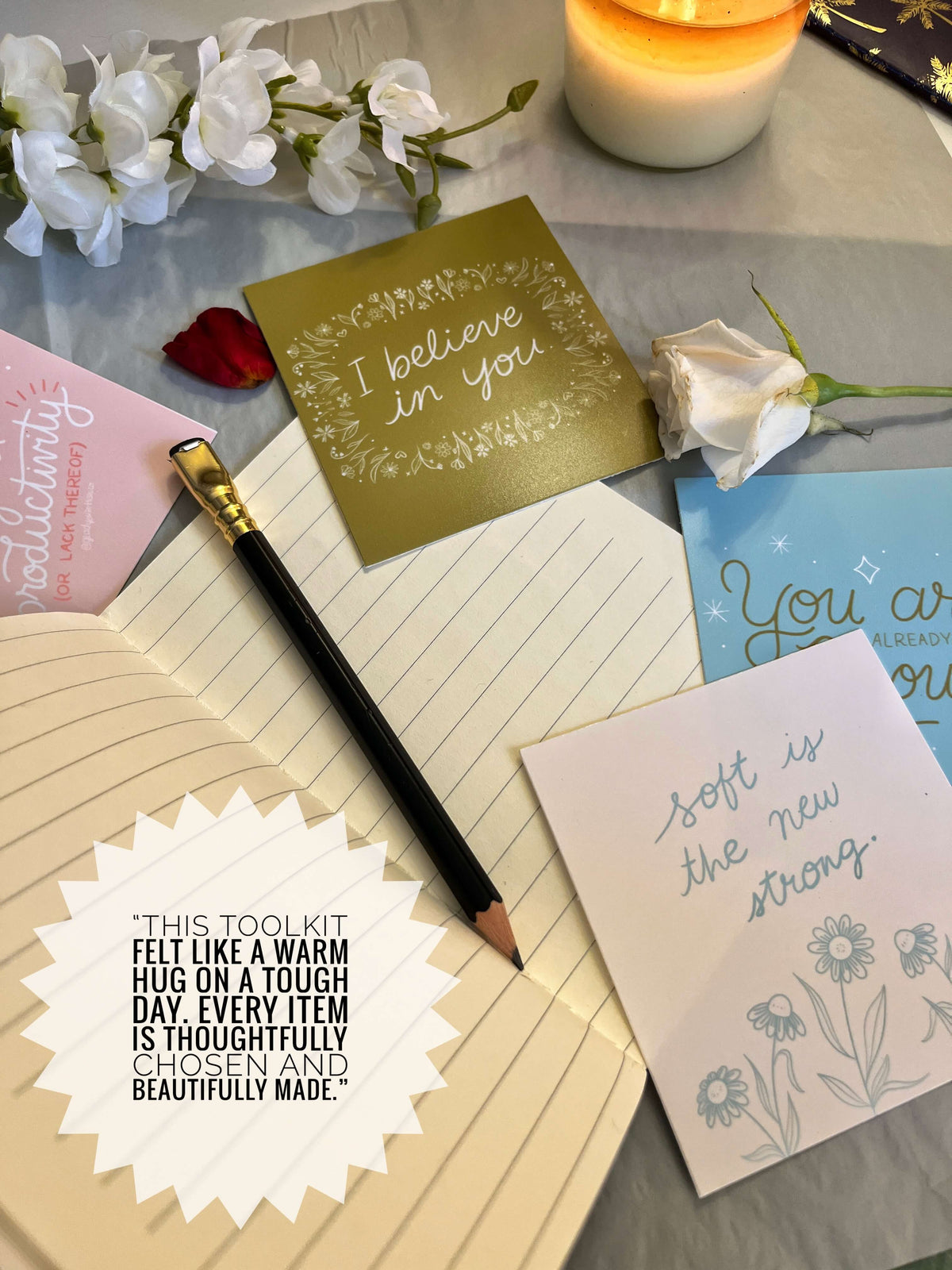 Notebook, cards, and pen on a surface with decorative elements