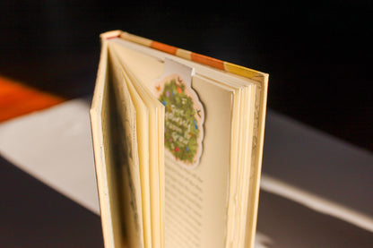 Open book with a decorative page featuring a floral design on a dark background
