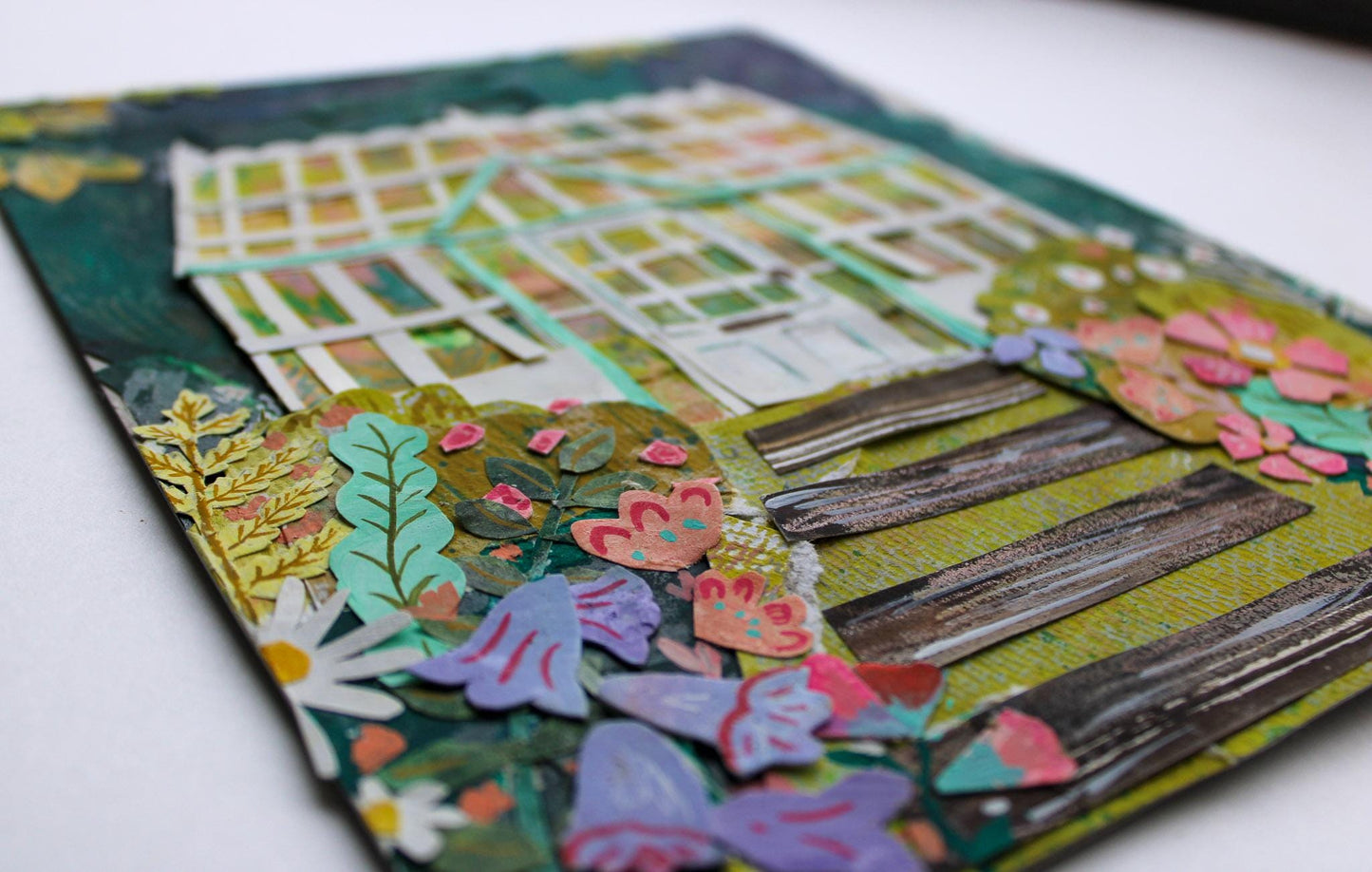 Colorful paper craft with floral and butterfly designs on a white background