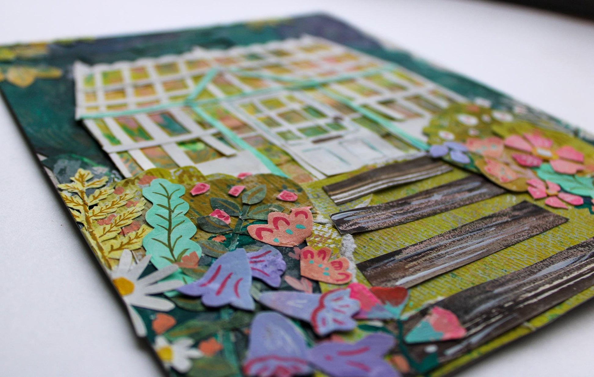 Colorful paper craft with floral and butterfly designs on a white background