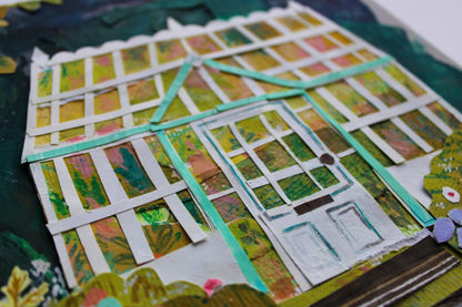 Decorative paper house with colorful window panes on a textured surface